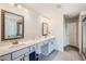 Bright bathroom featuring a double vanity, framed mirrors, and tile flooring at 207 Eagles Flight, Villa Rica, GA 30180