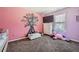 Whimsical bedroom with pink walls, mural, and modern furniture at 207 Eagles Flight, Villa Rica, GA 30180