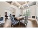 Dining room featuring a wood table, stylish blue patterned chairs, coffered ceiling, and hardwood floors at 207 Eagles Flight, Villa Rica, GA 30180