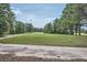 Scenic view of well-maintained golf course surrounded by lush greenery and tall trees at 207 Eagles Flight, Villa Rica, GA 30180