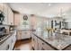 Open concept kitchen with granite counters, tiled backsplash, island with seating, and gas cooktop stove at 207 Eagles Flight, Villa Rica, GA 30180