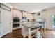 Bright kitchen with white cabinets, granite island, stainless steel appliances and access to a backyard deck at 207 Eagles Flight, Villa Rica, GA 30180