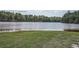 Scenic view of the lake surrounded by lush trees, offering a serene and peaceful environment at 207 Eagles Flight, Villa Rica, GA 30180