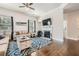 Cozy living room with a fireplace, hardwood floors, large windows and comfortable seating at 207 Eagles Flight, Villa Rica, GA 30180