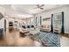 Spacious living room with hardwood floors, white walls, large windows, and open floor plan to kitchen at 207 Eagles Flight, Villa Rica, GA 30180