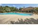 Resort-style swimming pool with tanning deck and community clubhouse in the background at 207 Eagles Flight, Villa Rica, GA 30180