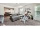 Sitting room with neutral walls, sitting area with large gray couch and doorway to bedroom at 207 Eagles Flight, Villa Rica, GA 30180