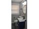 Modern bathroom features stylish vanity with sink, gold fixtures, updated toilet, and a window at 26 Reeves St, Norcross, GA 30071