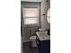 Modern bathroom features stylish vanity with sink, gold fixtures, updated toilet, and a window at 26 Reeves St, Norcross, GA 30071