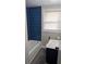 Updated bathroom features tiled shower/tub, vanity sink with gold fixtures, modern toilet, and a window at 26 Reeves St, Norcross, GA 30071