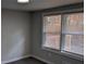 Bright bedroom with carpet flooring features two large windows and modern trim at 26 Reeves St, Norcross, GA 30071