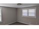 A bright bedroom featuring neutral walls, carpet flooring, and natural light from two windows at 26 Reeves St, Norcross, GA 30071