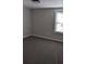 A cozy bedroom featuring neutral walls, carpet flooring, and natural light from a window at 26 Reeves St, Norcross, GA 30071