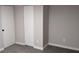 Neutral bedroom features gray carpet, modern trim, and closet with bifold doors at 26 Reeves St, Norcross, GA 30071