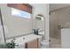 Bright bathroom featuring a soaking tub with black fixtures and a glass enclosed walk-in shower at 2810 Herrington Dr, Cumming, GA 30041