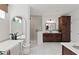 Bathroom featuring a modern soaking tub, frameless glass shower, and dark wood cabinetry at 2810 Herrington Dr, Cumming, GA 30041