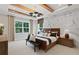 Serene bedroom with wooden beam ceiling, chandelier, with marble accent wall and large windows at 2810 Herrington Dr, Cumming, GA 30041