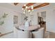Bright dining room with modern light fixture, wood beam ceiling, and elegant decor at 2810 Herrington Dr, Cumming, GA 30041