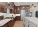 A chef's kitchen showcasing wood cabinets, modern stainless steel appliances, and white countertops at 2810 Herrington Dr, Cumming, GA 30041