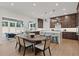 An open-concept kitchen featuring a center island, dark cabinets, and stainless steel appliances at 2810 Herrington Dr, Cumming, GA 30041