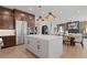 An open-concept kitchen with a large white island and stainless steel appliances flowing into the living area at 2810 Herrington Dr, Cumming, GA 30041