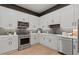 A well-lit kitchen features white cabinets, stainless steel appliances, and a gray backsplash at 2810 Herrington Dr, Cumming, GA 30041