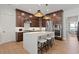 A gourmet kitchen featuring dark cabinets, stainless steel appliances, and a large white waterfall island with seating at 2810 Herrington Dr, Cumming, GA 30041