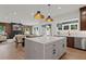 A bright kitchen with a center island that flows into the dining and living areas at 2810 Herrington Dr, Cumming, GA 30041