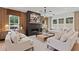Stylish living room featuring a modern fireplace and wood accent wall at 2810 Herrington Dr, Cumming, GA 30041