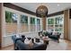 Bright living room featuring large windows, stylish seating, and a decorative light fixture at 2810 Herrington Dr, Cumming, GA 30041