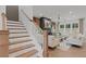 Open-concept living room with a fireplace, staircase, and ample natural light at 2810 Herrington Dr, Cumming, GA 30041