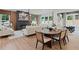 A modern living room with hardwood floors and a dining area with a fireplace and large windows at 2810 Herrington Dr, Cumming, GA 30041