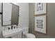 Modern powder room boasts clean lines, elegant fixtures, and decorative wall art at 2810 Herrington Dr, Cumming, GA 30041