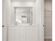 Bright bathroom features double sinks, white cabinets, and a large mirror and linen closet at 4183 Viola Pl, Atlanta, GA 30349