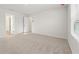 Spacious bedroom with neutral carpet, lots of light, and a connected bathroom at 4183 Viola Pl, Atlanta, GA 30349