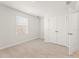 Cozy bedroom featuring neutral carpet, double-door closet, and lots of light at 4183 Viola Pl, Atlanta, GA 30349