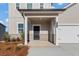 Inviting front porch with stone accents and a black front door, address number visible at 4183 Viola Pl, Atlanta, GA 30349