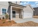 Inviting front porch with stone accents and a black front door, address number visible at 4183 Viola Pl, Atlanta, GA 30349