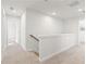 Upstairs hallway featuring carpet, white walls, and railing at 4183 Viola Pl, Atlanta, GA 30349