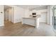 Open-concept kitchen and living area featuring hardwood floors and abundant natural light at 4183 Viola Pl, Atlanta, GA 30349