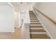Elegant staircase with wooden steps, white risers, and wood handrail at 4183 Viola Pl, Atlanta, GA 30349