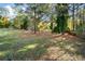 Spacious backyard with mature trees and shed, offering privacy at 689 Concord Sw Rd, Smyrna, GA 30082