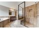 Primary bathroom with walk-in shower, soaking tub, and natural stone tile at 6145 Grindle Rd, Cumming, GA 30041