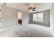 Comfortable bedroom with ceiling fan, neutral carpet, and an en-suite bathroom at 6145 Grindle Rd, Cumming, GA 30041