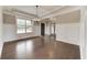 Light-filled dining room with hardwood floors, chandelier, and large window at 6145 Grindle Rd, Cumming, GA 30041