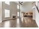 Open-concept living room with fireplace, hardwood floors, and two-story ceilings at 6145 Grindle Rd, Cumming, GA 30041