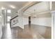 Open-concept living room and dining room with hardwood floors and wainscotting at 6145 Grindle Rd, Cumming, GA 30041