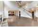 Bright, open living room with fireplace, hardwood floors, and staircase to the second floor at 6145 Grindle Rd, Cumming, GA 30041