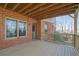 Wooden back porch with brick walls and an open view to the backyard at 3423 Mulberry Lane Ct, Dacula, GA 30019