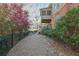 Landscaped backyard featuring a covered porch, decorative trees, and beautiful natural foliage at 3423 Mulberry Lane Ct, Dacula, GA 30019